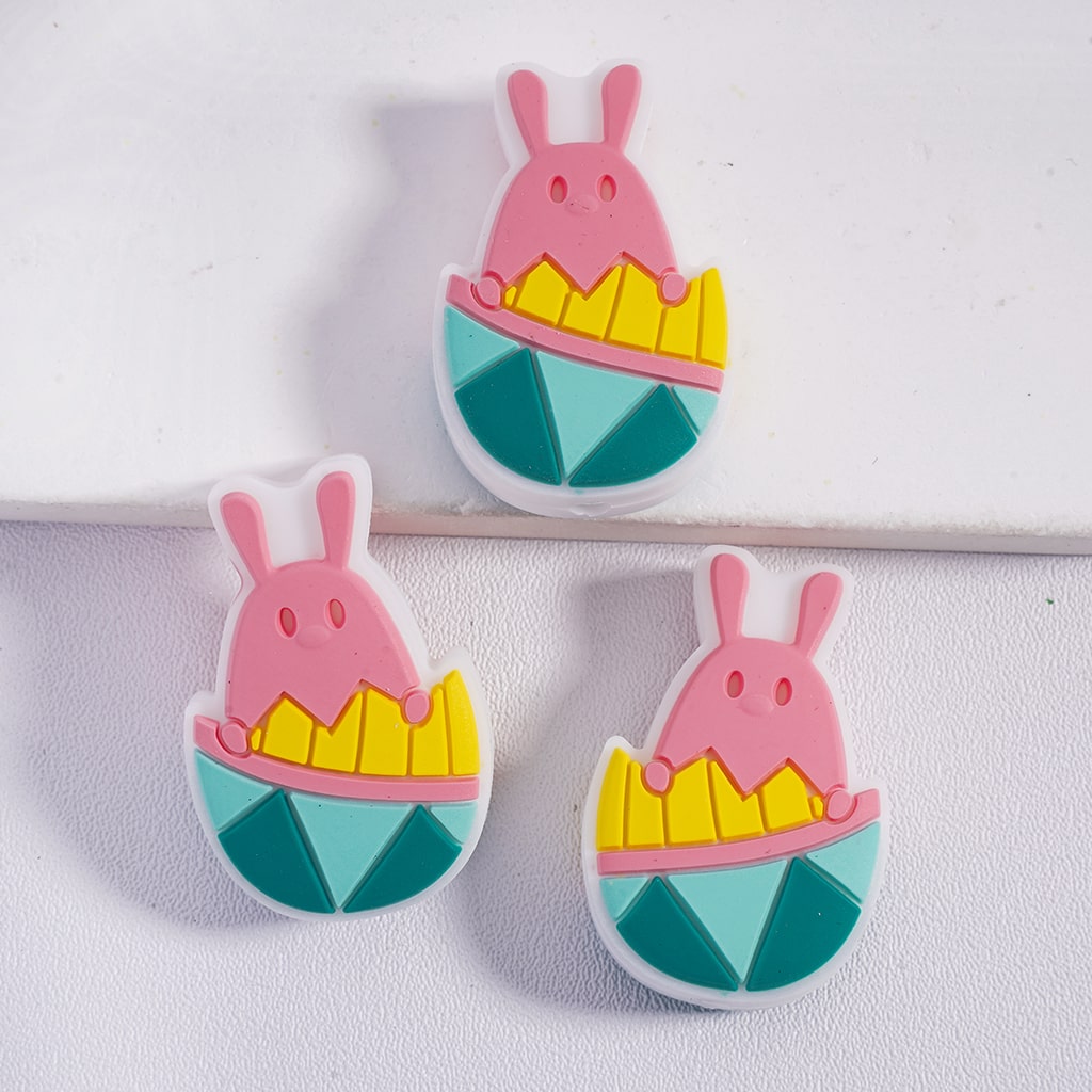 Three colorful bunny-shaped earrings on a white background