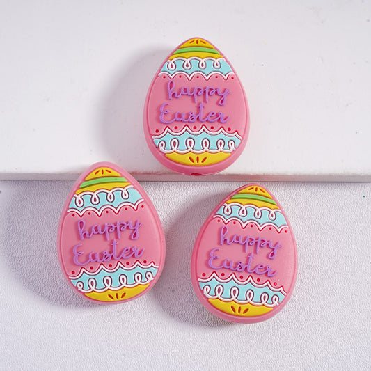 Three pink 'Happy Easter' egg-shaped cookies on a white background