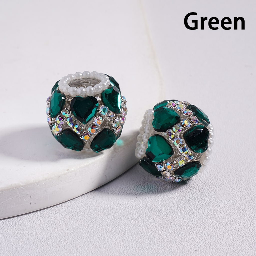 Green gemstone earrings on a white surface with 'Green' text above.