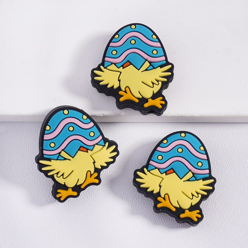 Three colorful gnome-shaped pins with blue hats on a white background
