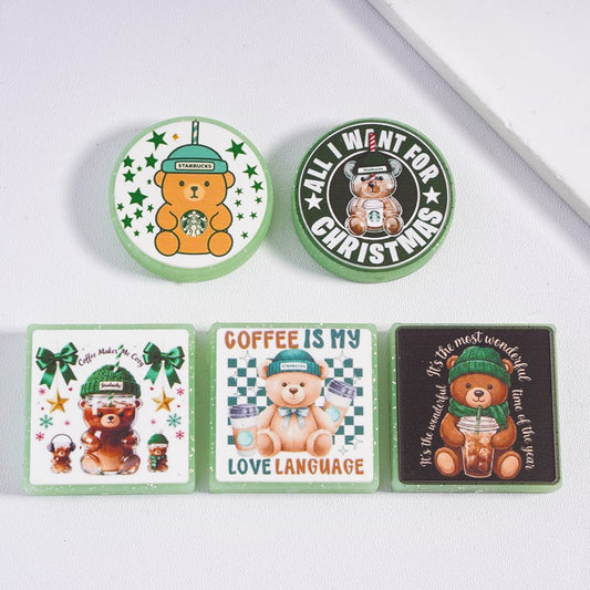 Set of bear-themed coasters with Starbucks branding on a white surface