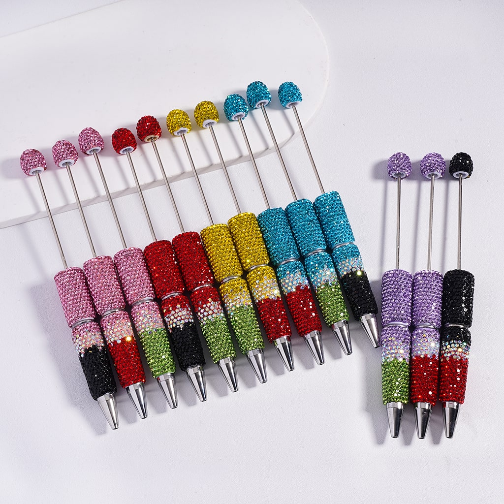 Set of colorful pens with rhinestone accents on a white background