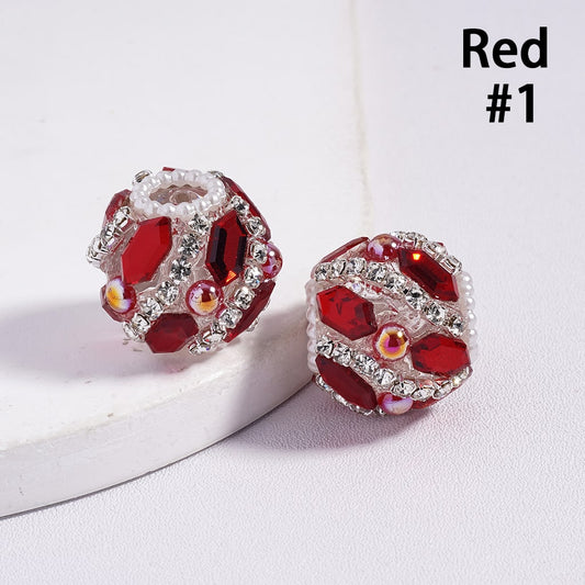 Red gemstone earrings with clear stones on a white background