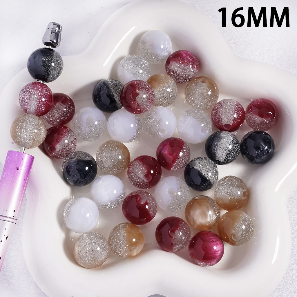 Assorted colored beads on a white dish with a purple tool, labeled '16MM'.

