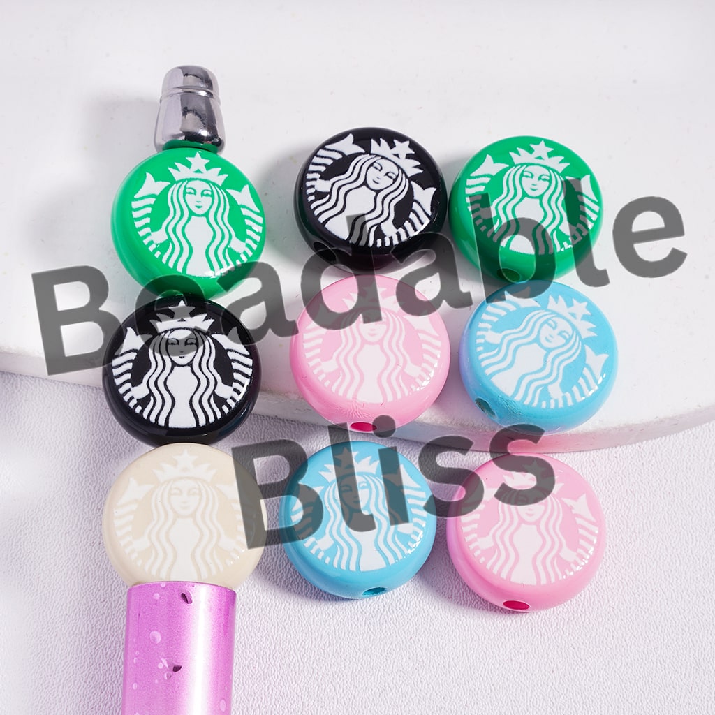 Starbucks-themed bottle caps in various colors on a white background

