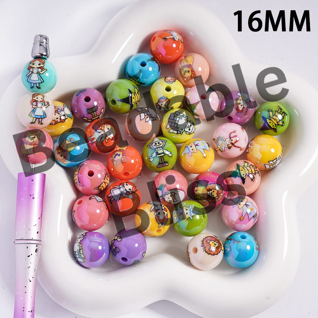 Colorful cartoon-themed beads on a white heart-shaped tray with a pink pen.