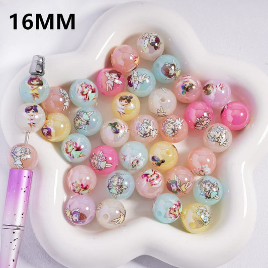 Colorful beads with floral designs on a heart-shaped white dish, with a pen for scale.