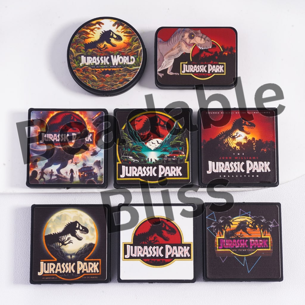 Set of 'Jurassic Park' and 'Jurassic World' coasters on a white background