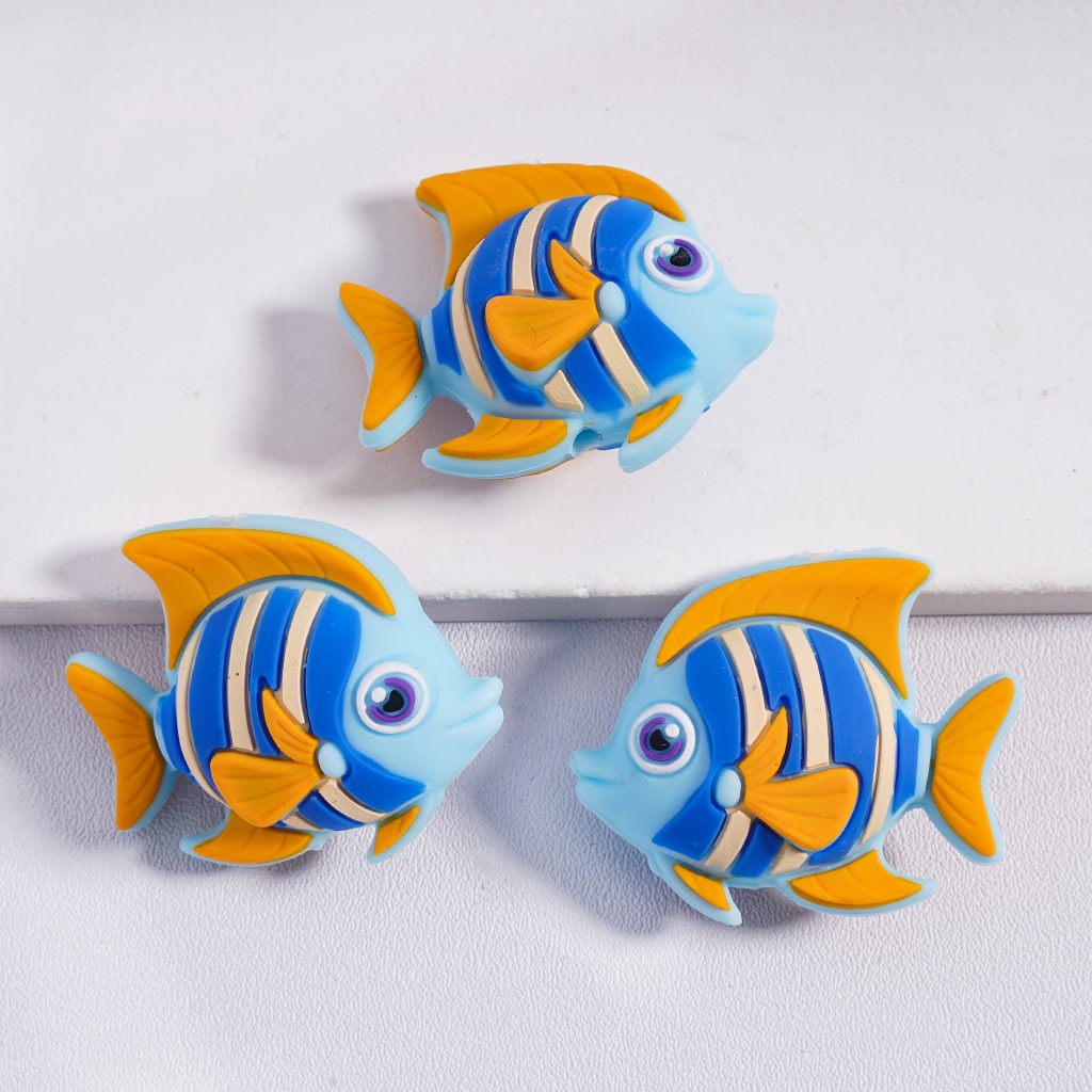 Three blue and orange fish-shaped objects on a white background