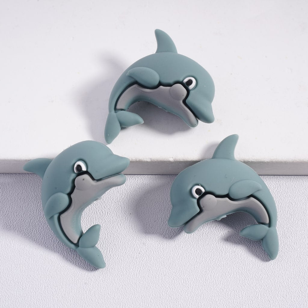 Three cartoon dolphin clips on a white background