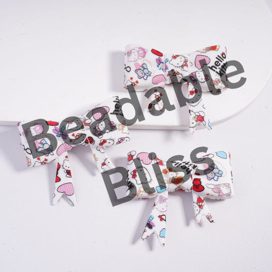 Three fabric bows with Hello Kitty design on a white background, branded 'handsonsupply.com'.