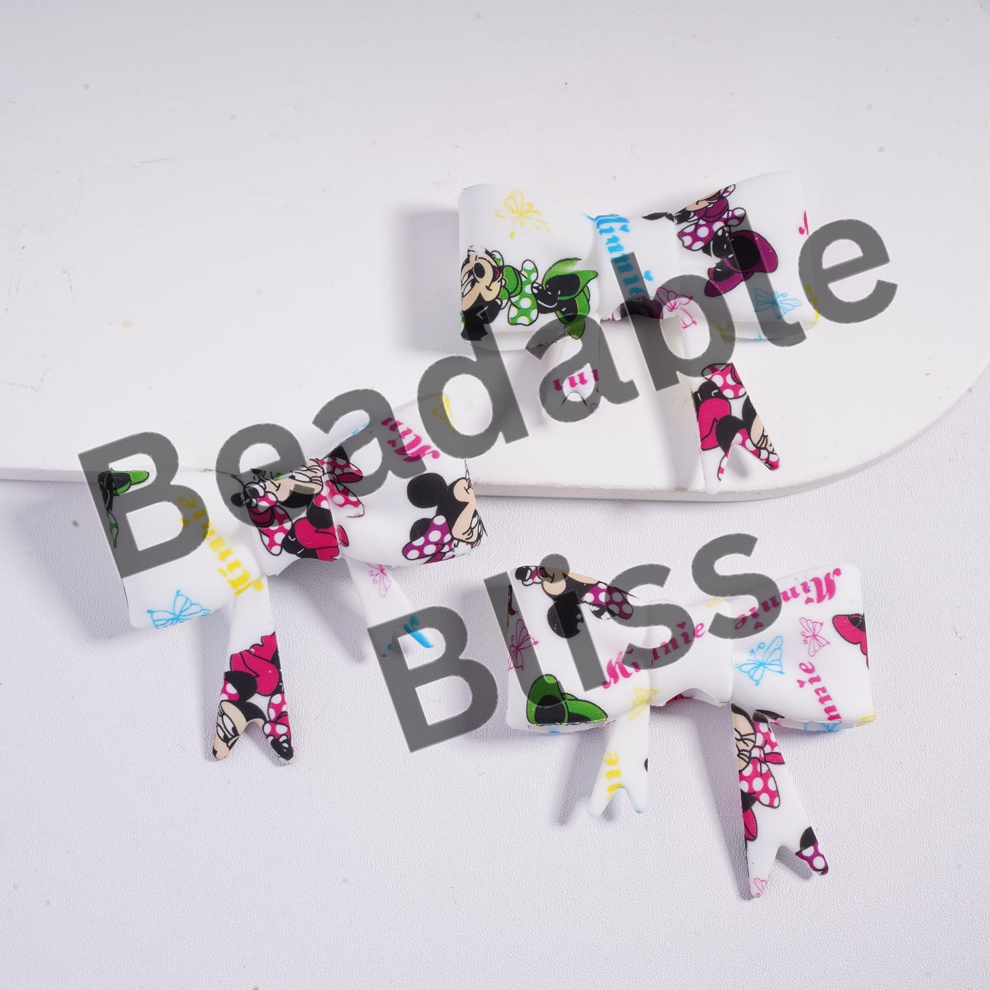 Set of Minnie Mouse-themed hair bows on a white background with 'beadablebliss.com' branding.

