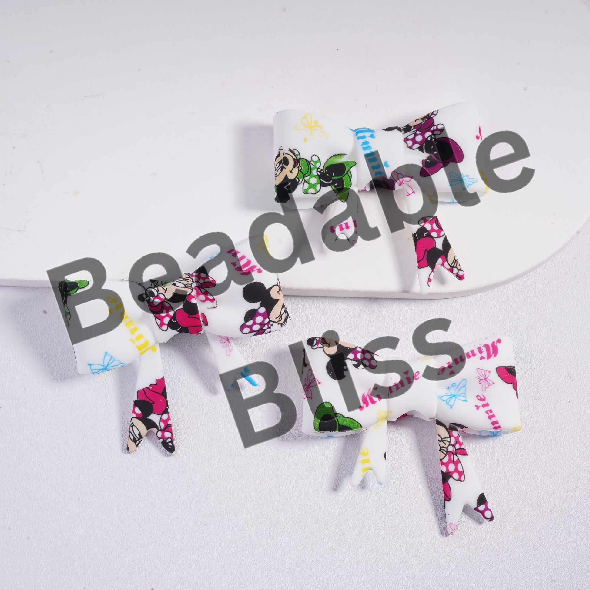 Set of Minnie Mouse-themed hair bows on a white background with 'beadablebliss.com' branding.

