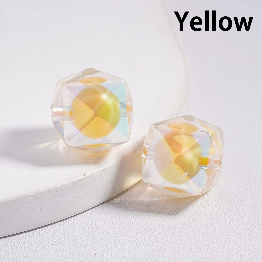 Dodecahedral yellow crystal beads on a white surface with 'Yellow' text above.

