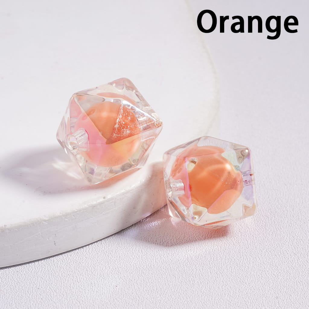 Crystal-like orange earrings on a white background with 'Orange' text.

