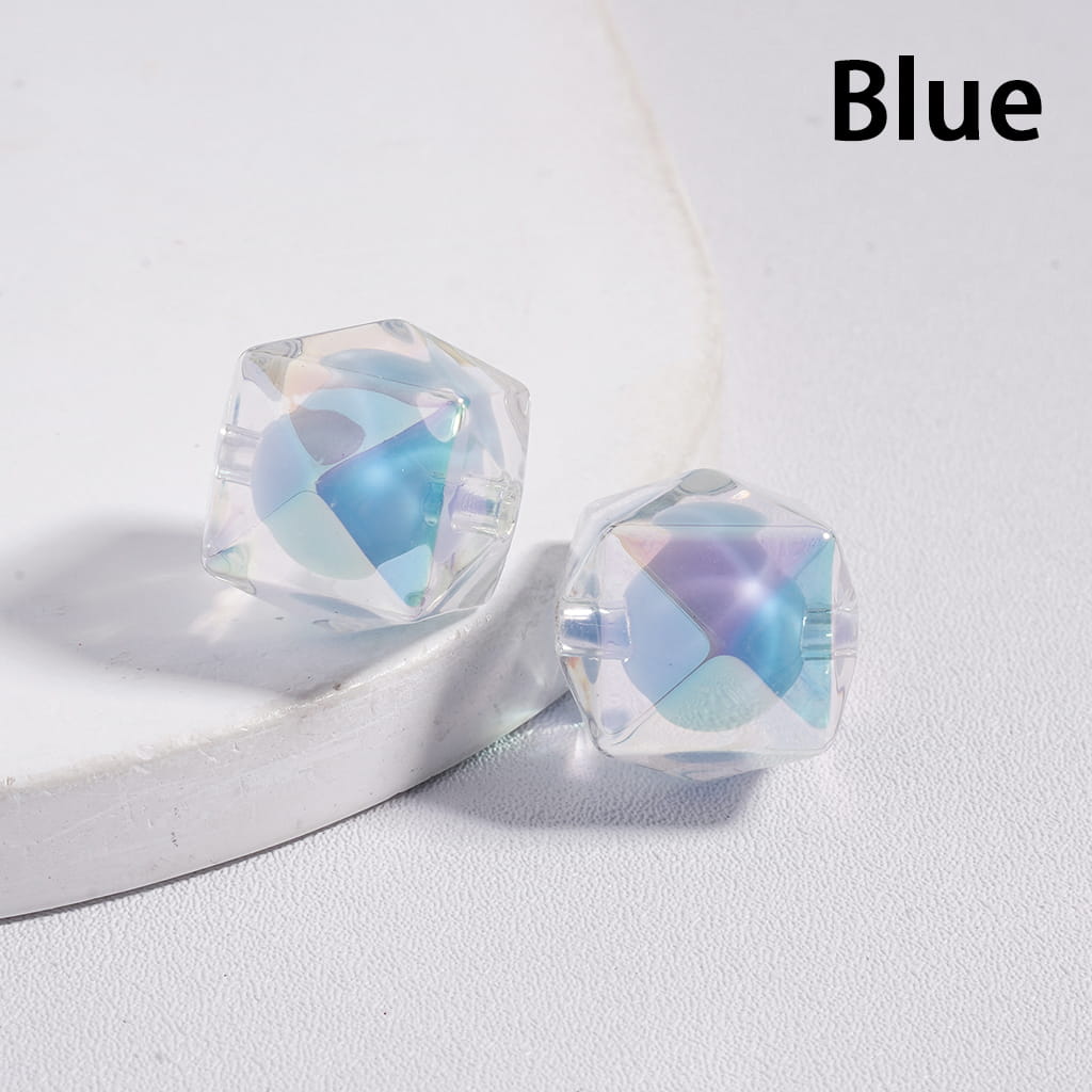 Blue geometric earrings on a white surface with 'Blue' text above.

