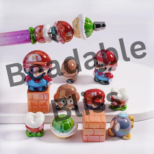 Collection of colorful Mario-themed figurines on a white surface with 'hansonsupply' branding.
