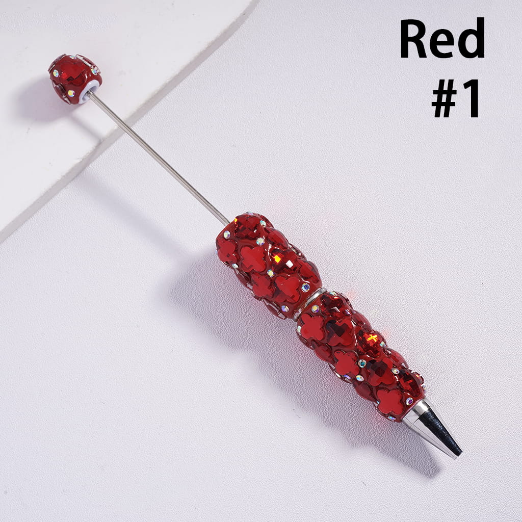 Red beaded pen on a light gray background with 'Red #1' text.