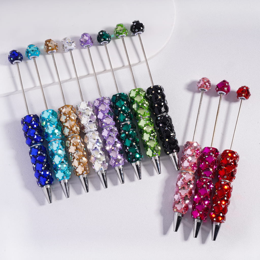Colorful beaded pen caps on a white background