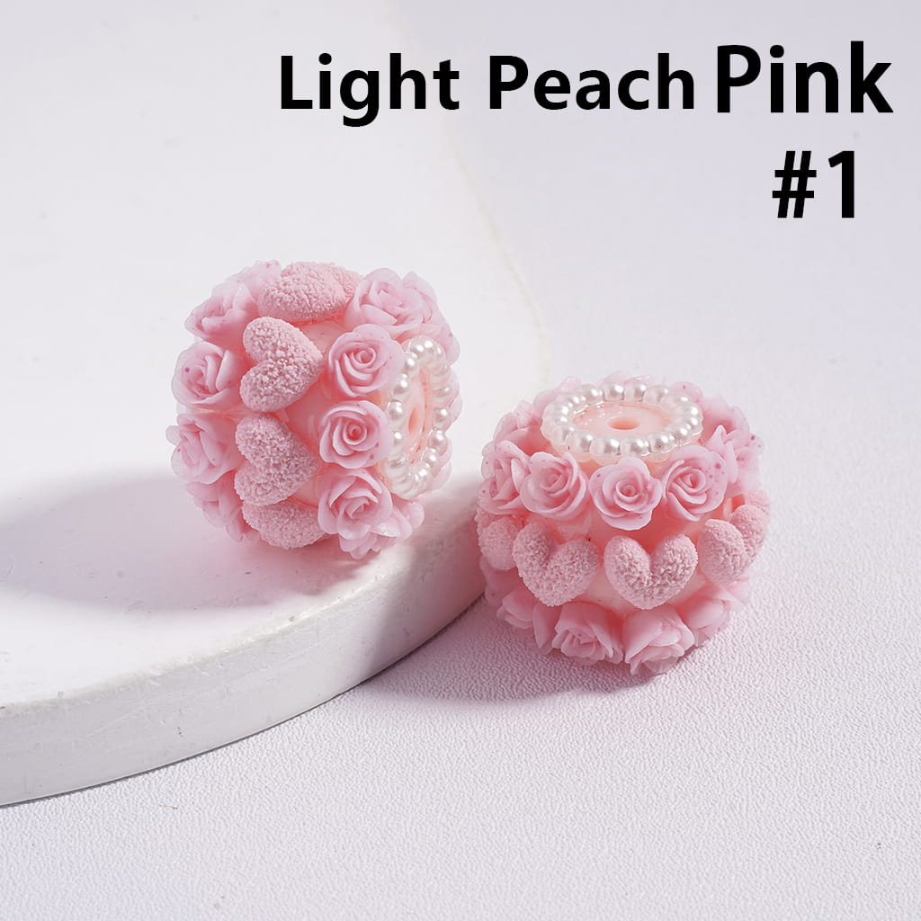 Light peach pink earrings with floral design on a white background