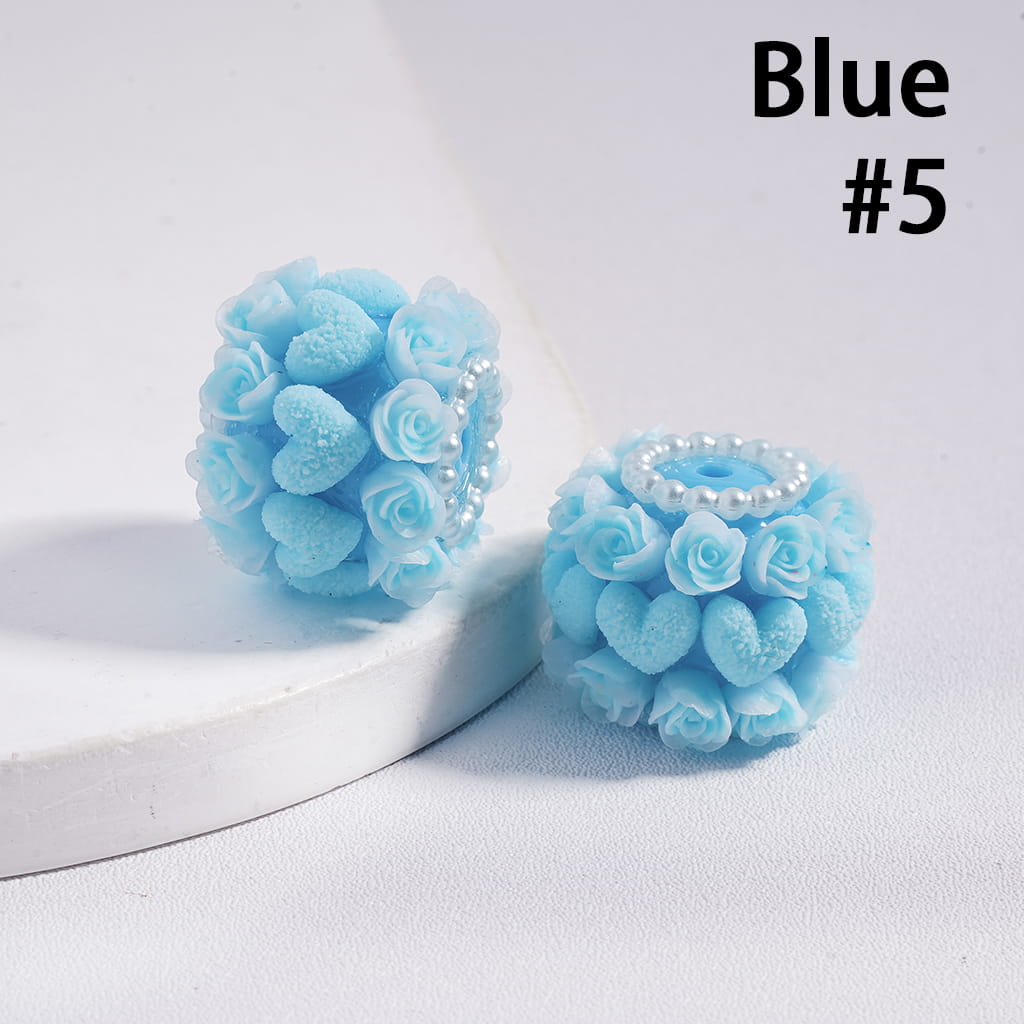 Pair of blue floral earrings with a white base on a light gray background