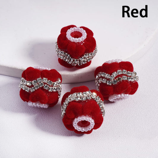 Red floral hair accessories with silver embellishments on a white background