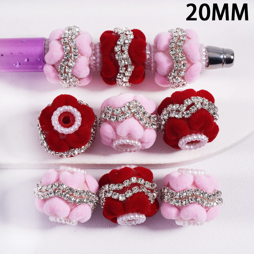 Decorative beads with pink and red flowers and rhinestones on a white background, labeled '20MM'.