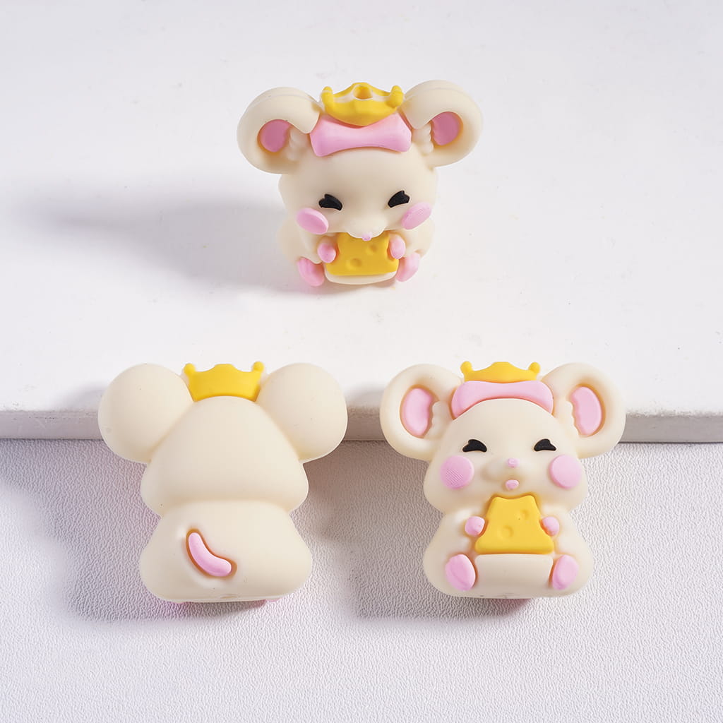 Three cartoon mouse figurines with yellow crowns and pink cheeks on a light gray background