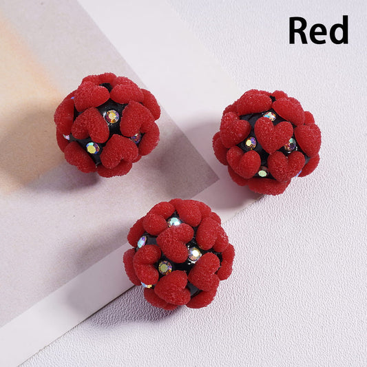 Red floral earrings with gemstones on a light background