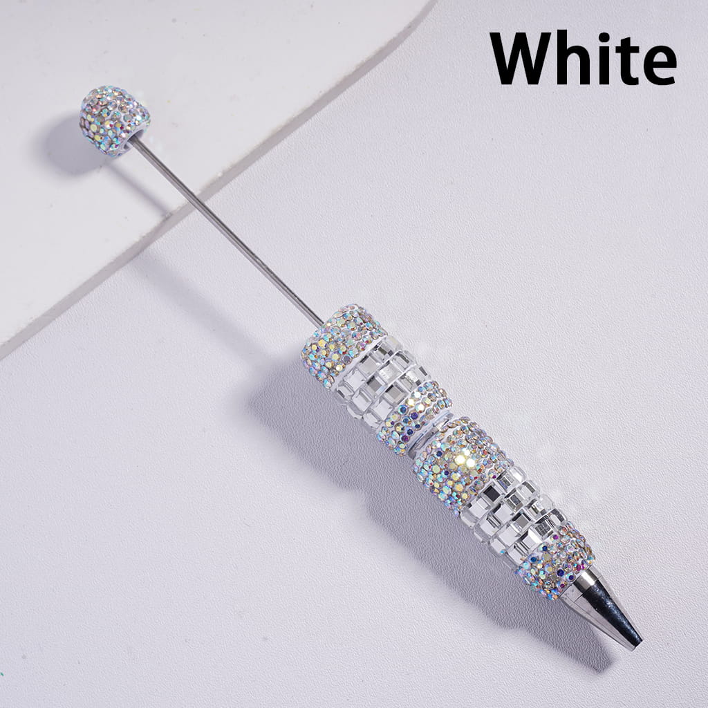 Decorative pen with gemstone accents on a white background