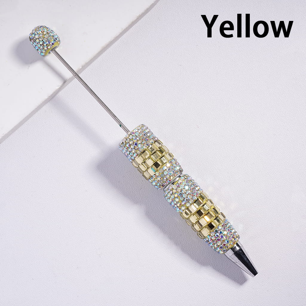 Decorative pen with gemstone accents on a light background