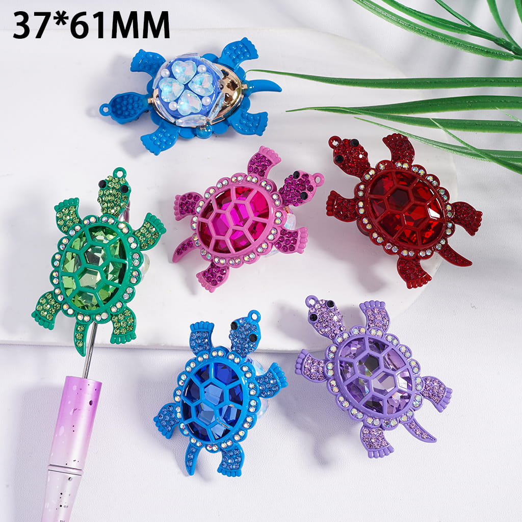 Colorful turtle-shaped hair accessories on a white background with green leaves.