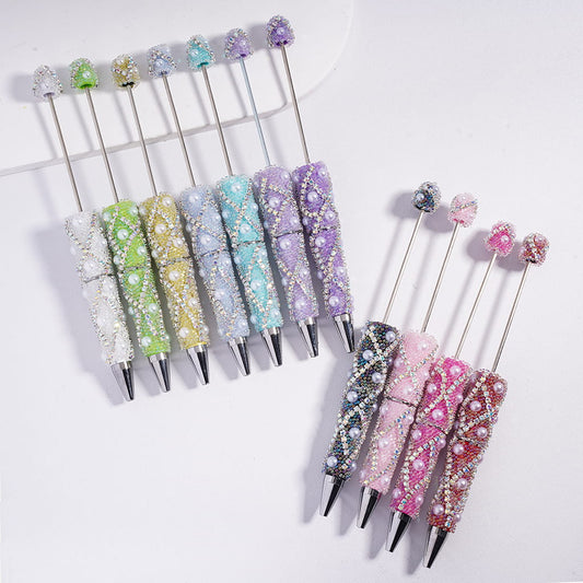 Decorative pens with gemstones in various colors on a white background