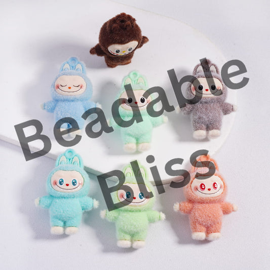 Colorful small plush toys in various costumes on a white background with 'beadablebliss.com' branding.

