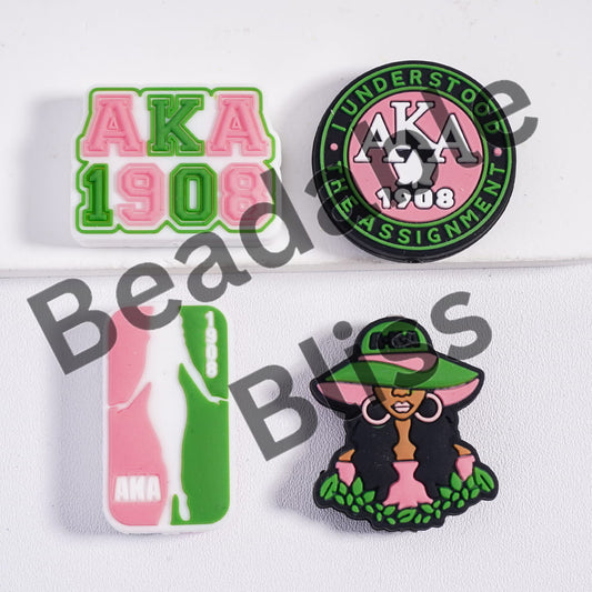Collection of AKA pins with various designs on a light blue background

