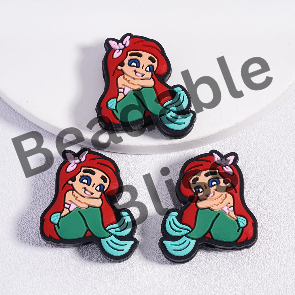 Mermaid character with red hair and green tail on a white background

