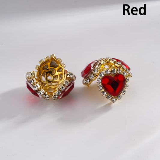 Gold and red earrings on a white background
