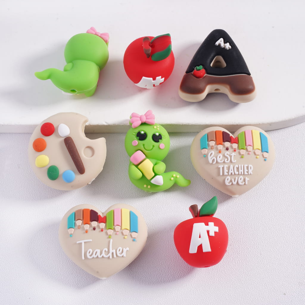 Set of colorful teacher-themed erasers on a white background