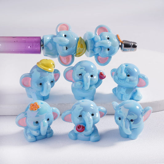 Set of blue elephant figurines with various accessories on a white background