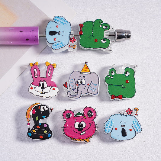 Set of colorful animal-shaped pins on a white background