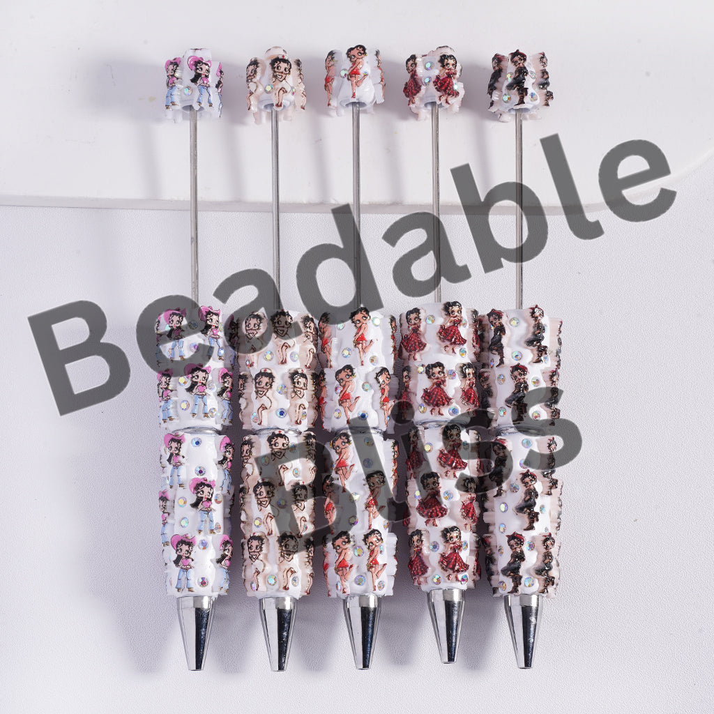 Set of pens with decorative tops featuring a pattern of a woman's face on a white background, branded 'handsontupply'.