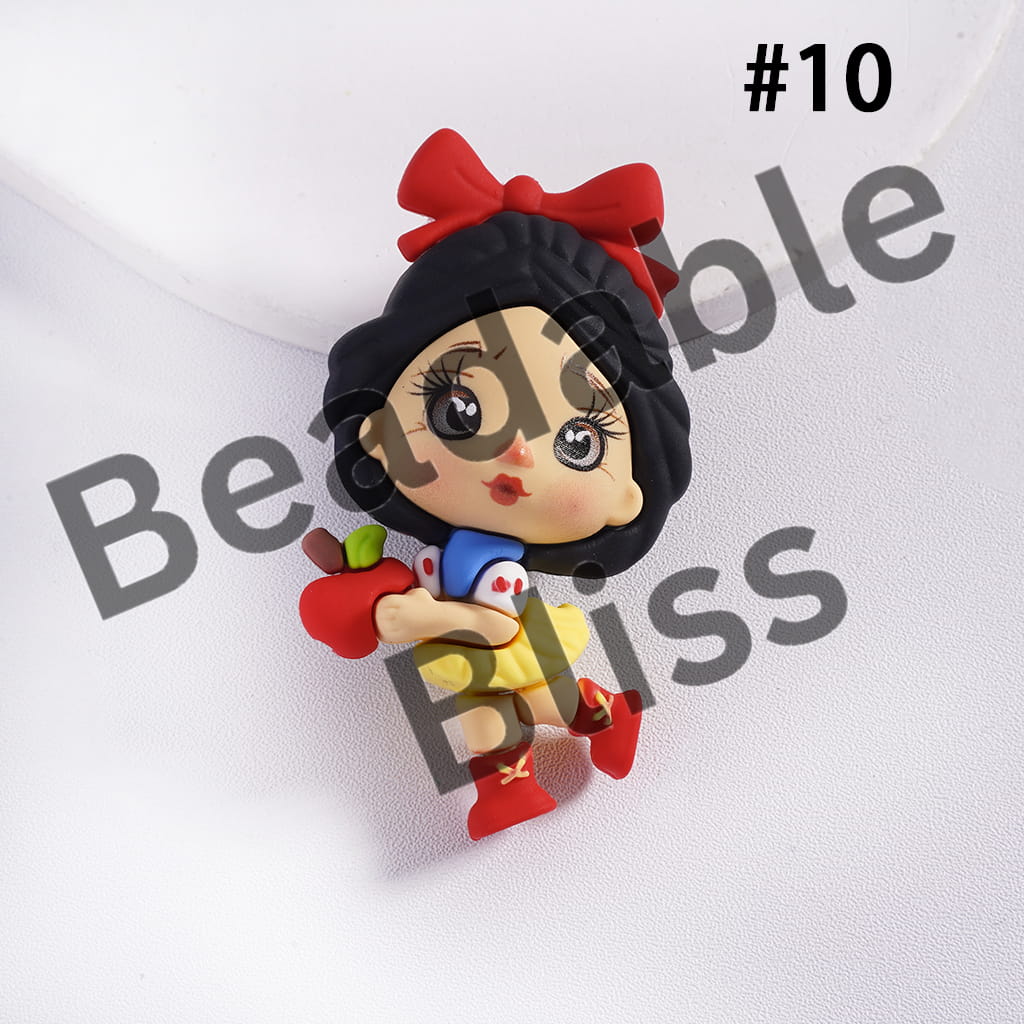 Character figurine with black hair, red bow, and holding an apple on a white background with 'handmade supply.com' text.