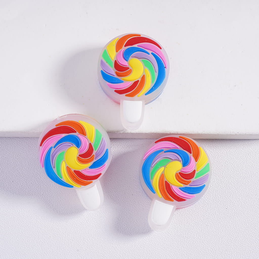 Colorful lollipop-shaped earbuds on a white background