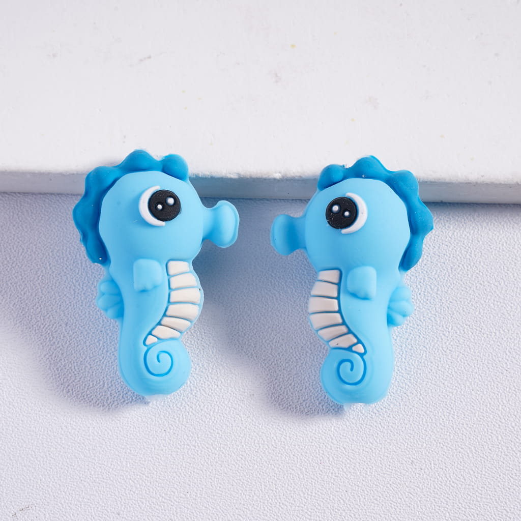 Two blue seahorse-shaped objects on a white background