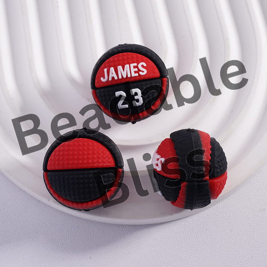 Black and red earrings with 'JAMES 23' text on a white background