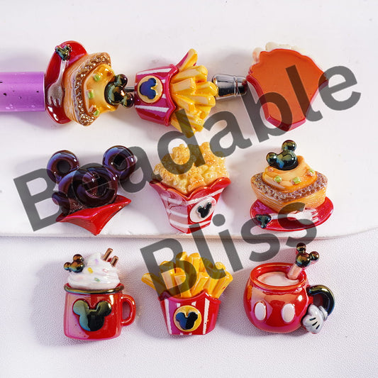 Colorful novelty items including a lollipop, ice cream cone, and fast food-themed clips on a white background.