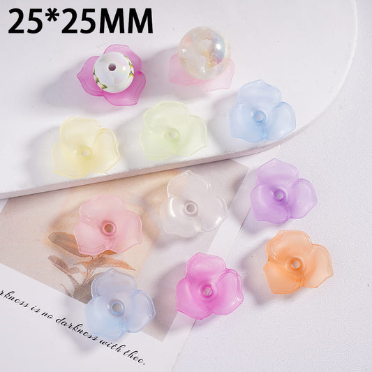 Colorful flower-shaped beads on a white surface with text indicating size.