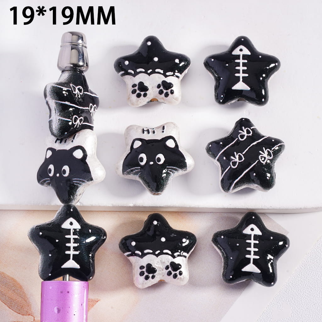 Black and white star-shaped charms with various designs on a white background