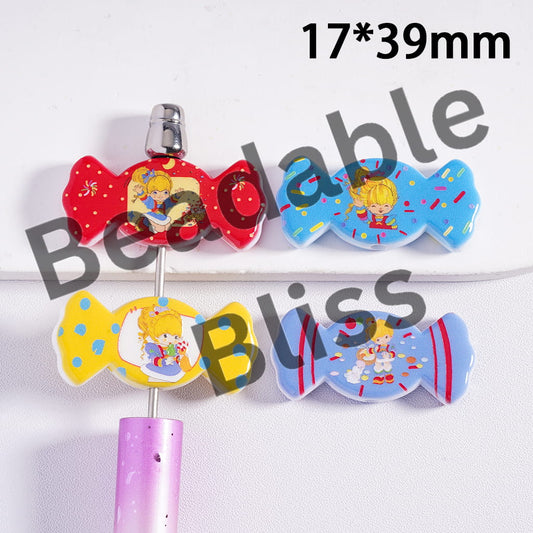 Colorful candy-shaped clips with cartoon character on a white background
