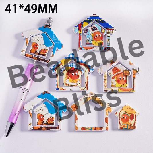 Set of cartoon-themed house-shaped magnets with a pen on a white background